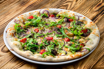 Italian pizza on a thin dough with a variety of stuffed. Mixed media