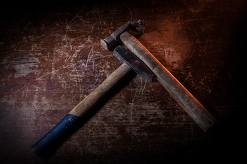 Tool work concept. hammer and nails on dark table