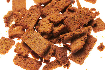 rye crackers, small dried pieces of bread with spices, delicious fast food isolated on white background