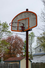 Closeup view of a dirty basketball backboard on a pole with no net