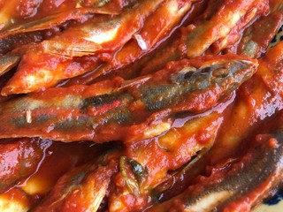 Donzella fishes cooked with tomato sauce