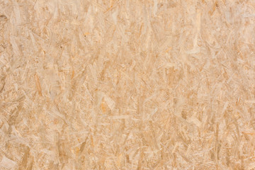 Plywood texture with fragments of compressed sawdust. Plywood background. Wooden texture. 