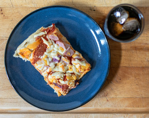 Ham, Onion and pepperoni pizza with a glass of cola