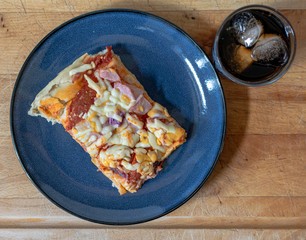Ham, Onion and pepperoni pizza with a glass of cola
