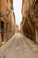 Fototapeta na wymiar Cozy narrow street in Ferrara, Emilia-Romagna, Italy.