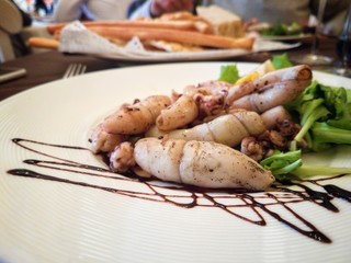 Sea Food tattlers gourmet in italian restaurant with balsamic modena vinegar and salad