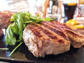 Filetto beef steak, with potatos and salad served on black roast grill