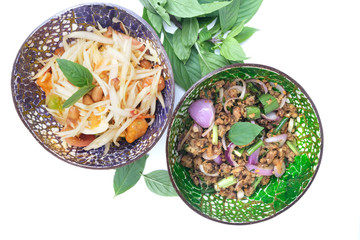 Top view of Papaya salad (Som Tam) and Minced Catfish Spicy Salad with Herbs (Larb Pla Dook), Hot and spicy, Thai food.