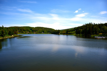 Fototapeta na wymiar dam in the forest with blue sky