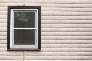 Fototapeta premium Exterior house wall with wood siding and a single window. Copy space. 
