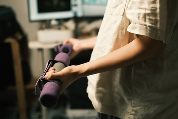 Unrecognized woman workout at home with Dumbbells medium closeup shot