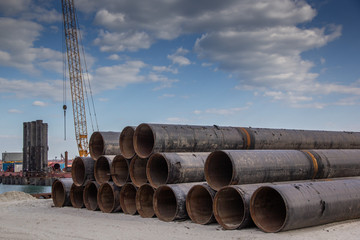 Large diameter tubular metal piles for berth construction