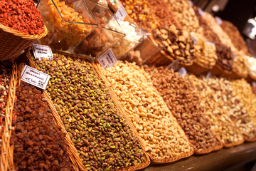 nuts and dried fruits on the counter in the market
