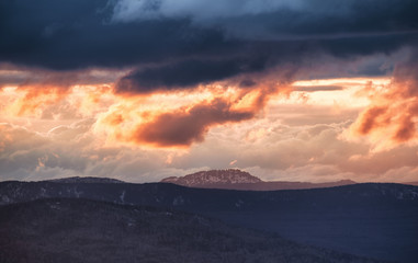 Orange Sun Setting Behind the Mountains