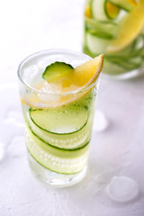 Cold and refreshing infused detox water with lemon and cucumber in a glas. Homemade flavored lemonade