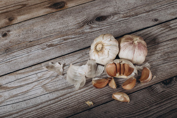 a bunch of garlic with husk. top view of garlic on a wooden background.