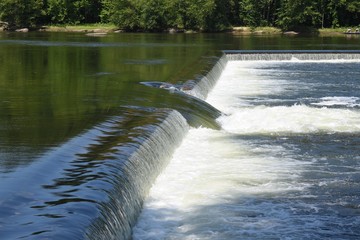water flowing over the dam