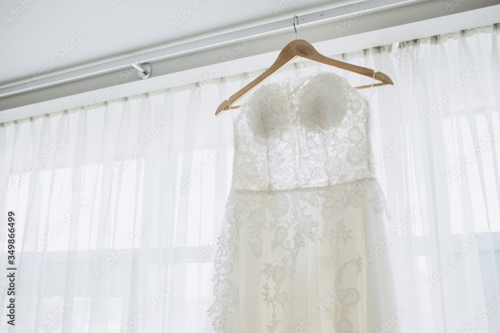 Wall mural white bride's dress. Detail of the dress close-up. The dress on a hanger.