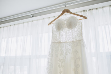white bride's dress. Detail of the dress close-up. The dress on a hanger.