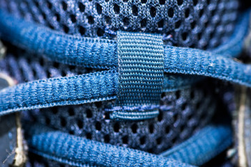 Blue shoelace on sport shoe close up macro shot for background.