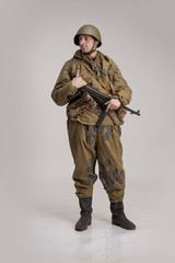 Actor man in an old military uniform and camouflage clothing of a soldier of the Soviet army during...