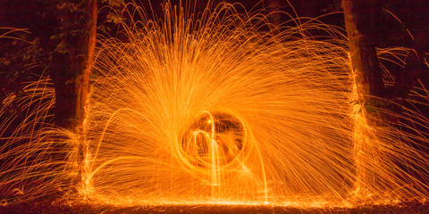 Whirl of sparks and flames on the river Neckar island (Neckarinsel) in Tuebingen illuminating the...