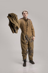 Actor man in an old military uniform and camouflage clothing of a soldier of the Soviet army during...
