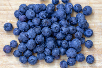 Lots of blueberries on wooden surface close-up