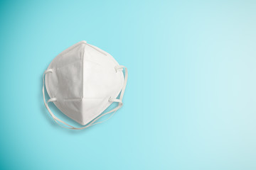 Isolated white Surgical face mask for protection Corona virus or COVID 19 and dust PM 2.5 on blue background . Healthcare and hygiene equipment concept. Photo include clipping path.