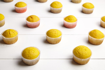 Muffins on white table. Cupcakes on wooden background. Homemade bakery