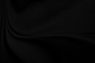 closeup abstract black cloth satin and silk fabric background.