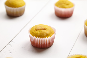 Muffins on white table. Cupcakes on wooden background. Homemade bakery