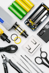 tool kit for maintenance and assembly of modern vaping device mod on white background. disassembled...