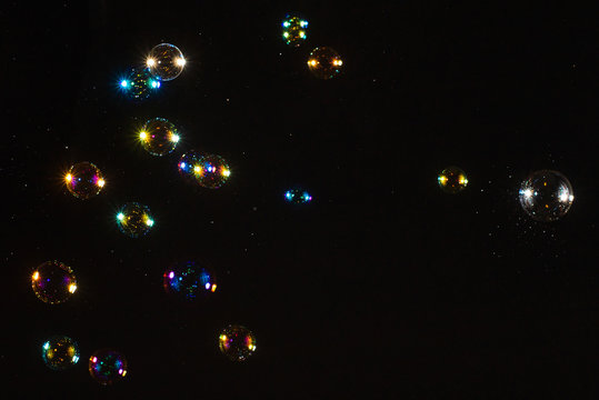 Soap bubbles isolated on a black background. Copy space.