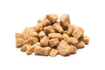 Brown sugar pieces isolated on white