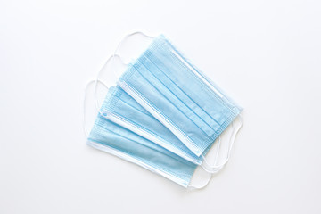 Fototapeta na wymiar three protective medical masks blue on a white background 