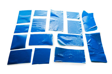 Blue scotch tape pieces isolated on white.