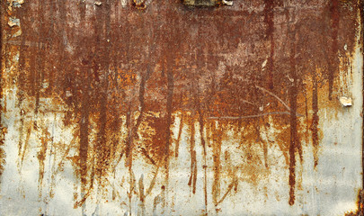 rusty surface with corrosion effect on a metal iron board with orange, brown and red colors over...