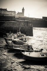 Fishing boats beached in the harbour, Porthleven, Cornwall, UK