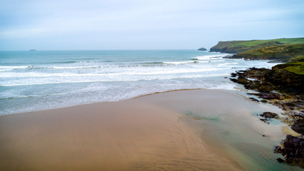 Fototapeta na wymiar Beach scene, waves and sand, Polzeath, Pentire point, UK