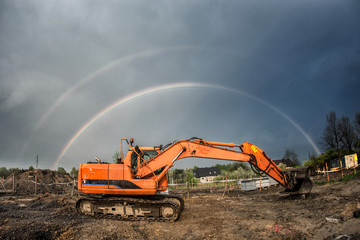 Rainbow on orange excavator digger  © Chawran