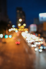 Blurred defocused lights of heavy traffic and blurred traffic road with colorful bokeh lights