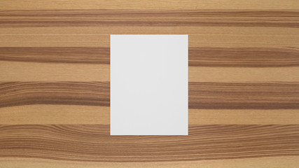Blank portrait sheet of paper on olive ash wood table