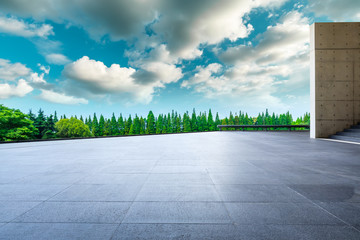 Empty square floor and green forest in natural park.