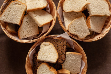 Board with tasty bread on background, top view. Space for text