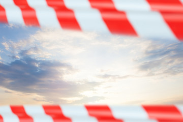 Fototapeta na wymiar Sky clouds with red warning tape, prohibition concept