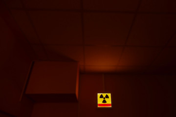 Radioactive (ionizing radiation) round yellow and black danger symbol painted on a massive rusty...