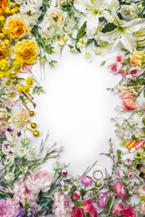 Top view of round frame with decoration artificial flowers, branches, leaves, petals, instruments and paint. isolated on white background. 
