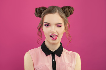 Nice funny model woman with fashion makeup on bright pink background