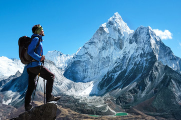 Climber reaches the summit of mountain peak. Success, freedom and happiness, achievement in...